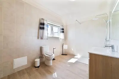 a bathroom with a toilet and a sink at Vivenda Lemos B in Albufeira