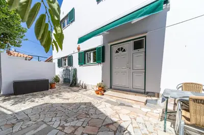 a white house with a door and a patio at Vivenda Lemos C in Albufeira