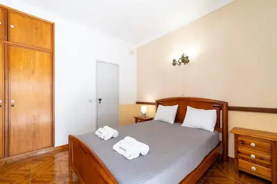 a bedroom with a bed with two towels on it at Vivenda Lemos C in Albufeira