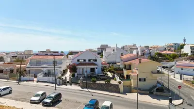 a city street with cars parked in front of houses at Vivenda Lemos D in Albufeira