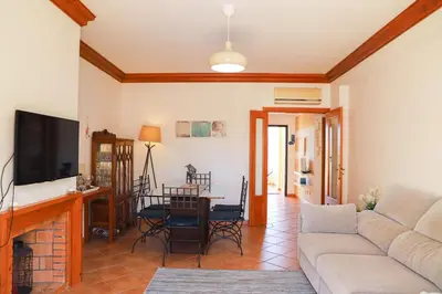 a living room with a couch and a table at Atlântida Golf Village by Garvetur in Quarteira