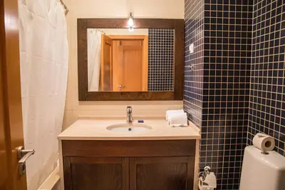 a bathroom with a sink and a mirror at Terraços do Milénio II by Garvetur in Quarteira