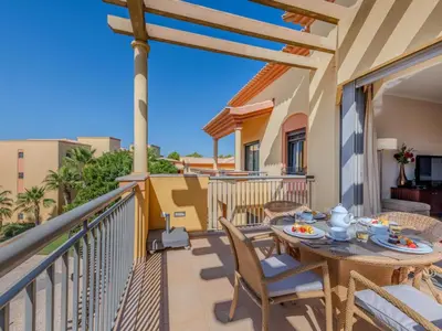 a patio with sliding glass doors with a table and chairs at Apartment The Residence at Victoria by Interhome in Vilamoura