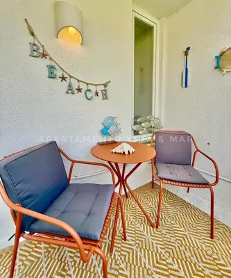 two chairs and a table in a room at Apartamento Vida & Mar at Albufeira Beach in Albufeira