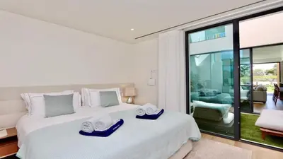 a bedroom with a large white bed with towels on it at Casa Bougainvillea by CleverDetails, private pool 