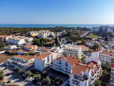an aerial view of a city with buildings and the ocean at Falésia Beach I by HelloVacations in Albufeira