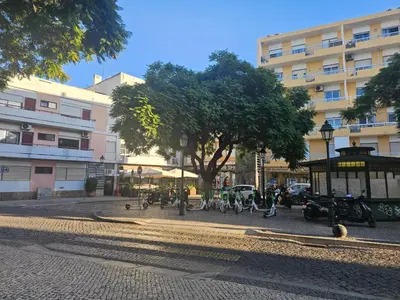 a group of people walking around in a street at Blife Olindya private rooms in Faro