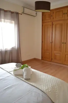 a bedroom with a bed with towels on it at Magnifique Villa à 10min de la mer in Faro