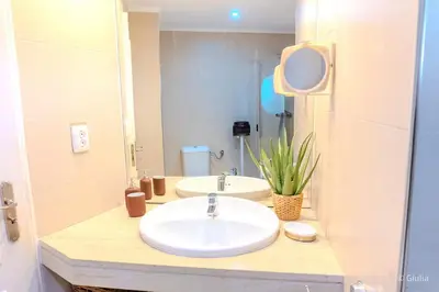 a bathroom with two sinks and a mirror at Algarve Vilamoura Quarteira vue sur Ocean-Portugal in Quarteira
