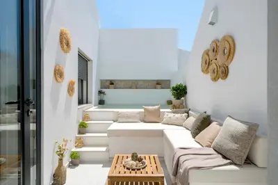 a living room with a couch and a table at Townhouse with Heated Pool in Downtown Faro in Faro