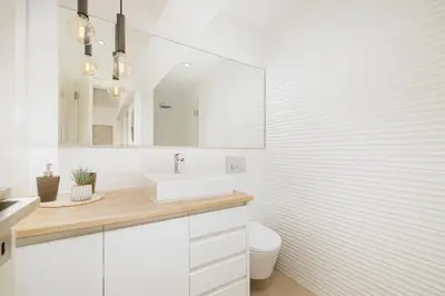 a white bathroom with a sink and a toilet at Top-Floor 2BR, Sea and city Views & Jacuzzi in Faro