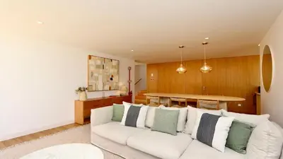 a living room with a white couch and a table at Villa Harmony - Natura Village by Cleverdetails in Quarteira