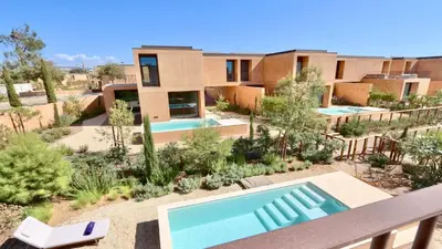 a house in the desert with a swimming pool at Villa Harmony - Natura Village by Cleverdetails in Quarteira