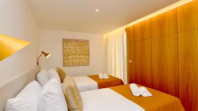 a hotel room with two beds and a closet at Villa Harmony - Natura Village by Cleverdetails in Quarteira