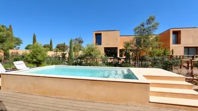 a swimming pool in front of a building at Villa Harmony - Natura Village by Cleverdetails in Quarteira