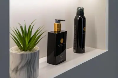 a bottle of wine on a shelf next to a plant at Downtown, 1br with a first row view over the sea in Faro