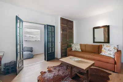 a living room with a couch and a table at Maison Jack in Albufeira
