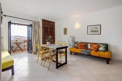 a kitchen with a red rug in a room at Maison Jack in Albufeira