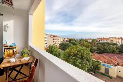 a balcony with a table and a view of a city at Maison Jack in Albufeira
