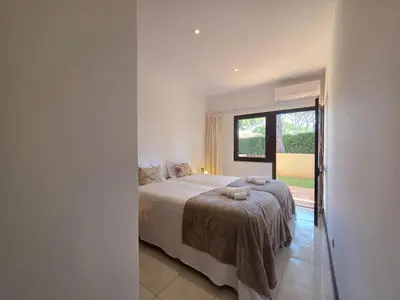 a bedroom with a bed and a large window at Cimo do Monte Natur by SAPvillas in Vilamoura