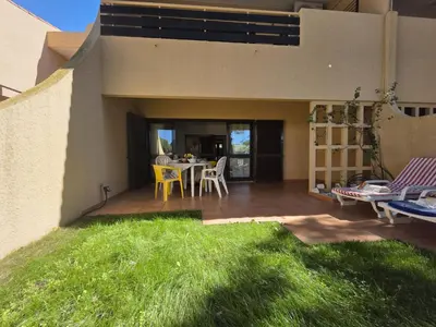 a house with a patio with a table and chairs at Cimo do Monte Natur by SAPvillas in Vilamoura