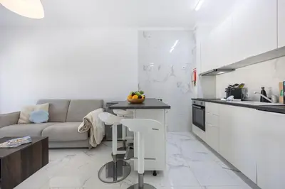 a kitchen and living room with a couch and a table at Nordic Breeze in Quarteira