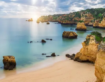 a view of a beach with rocks in the water at Nordic Breeze in Quarteira
