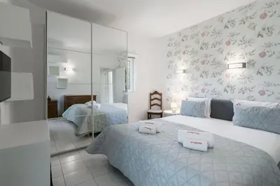 a bedroom with a bed with two towels on it at Sun & Sea Flat in Quarteira - Cozy Apartment Close to the Beach, by Hopstays in Quarteira