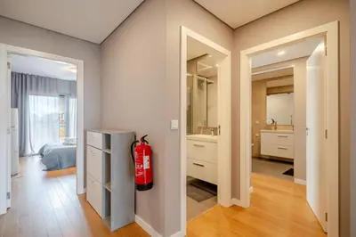 a bathroom with a fire extinguisher in a room at HolidaysPT - Sunset At Lux Terrace - 2 Bedroom Apt in Faro