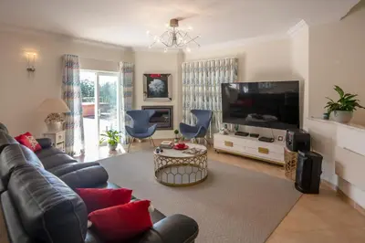 a living room with a couch and a flat screen tv at Amazing villa in Albufeira - Alke Vida in Albufeira