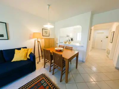 a living room with a table and a blue couch at Apartment with 2 bedrooms in Balaia, Olhos de Água, Albufeira in Albufeira