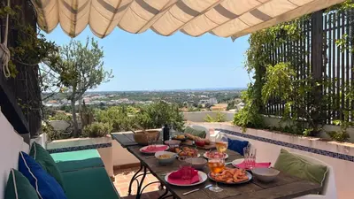 a table with food on top of a balcony at The Lemon Tree House by IntiHolidays in Boliqueime