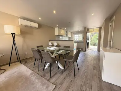 a kitchen and dining room with a glass table and chairs at Villa 23 - Ponta Grande Resort in Albufeira