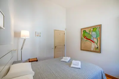 a bedroom with a bed with a painting on the wall at Your villa in Vilamoura in Quarteira