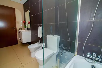 a bathroom with a toilet and a shower and a sink at Cavalo Preto Beach Resort Apt & Wi-Fi Nr Beach in Quarteira