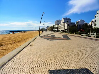 a street light on a sandy beach next to the ocean at Cavalo Preto Beach Resort Apt & Wi-Fi Nr Beach in Quarteira