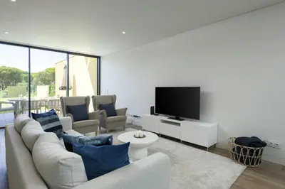 a living room with a couch and a tv at Vilamoura Parque - Luxury Villa with pool by HD in Vilamoura