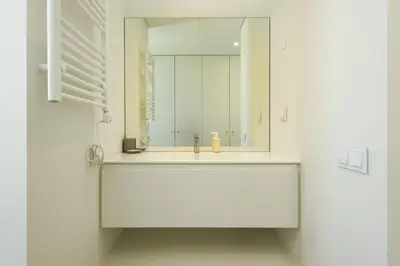 a white bathroom with a sink and a mirror at Vilamoura Parque - Luxury Villa with pool by HD in Vilamoura