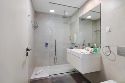 a white bathroom with a shower and a sink at Casa do Sol and Golf - Vilamoura in Vilamoura