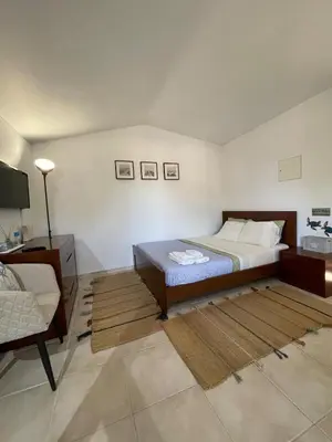 a bedroom with a bed and a desk and a chair at Estúdio na Falésia 2 in Olhos de Água