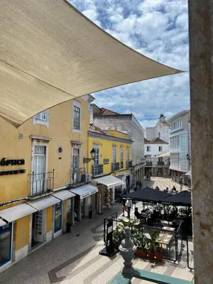 a view of a city street with buildings and umbrellas at OMG Faro in Faro