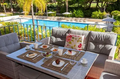 a table with plates of food on top of a couch at Vila Sol F5 Vilamoura 2BR by Enjoy your stay in Quarteira
