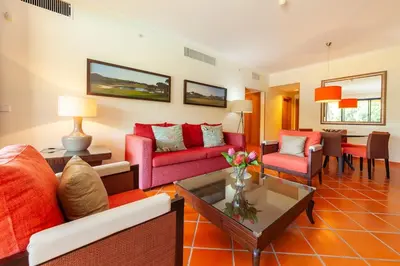 a living room with red furniture and a table at Vila Sol F5 Vilamoura 2BR by Enjoy your stay in Quarteira