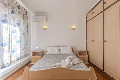 a bedroom with a bed with a towel on it at #348 Apartment Madaleno by Home Holidays in Roja- Pé