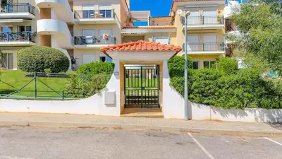 a bedroom with a bed with a teddy bear on it at Bragança Paradise in Albufeira
