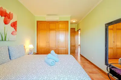 a bathroom with a toilet and a shower and a sink at Bragança Paradise in Albufeira
