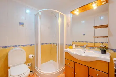 a bedroom with a bed and a tv and a balcony at Bragança Paradise in Albufeira