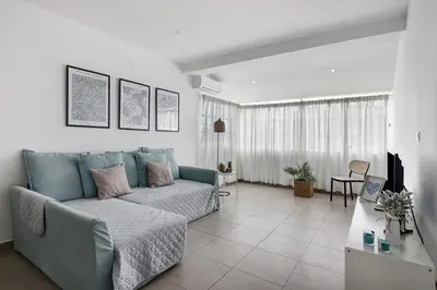 a living room with a couch and a table at Casa Machadinho in Albufeira