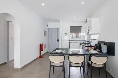 a kitchen with a table and four chairs in it at Casa Machadinho in Albufeira