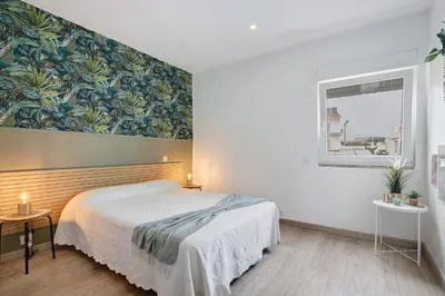 a bedroom with a bed and a wall mural at Casa Machadinho in Albufeira